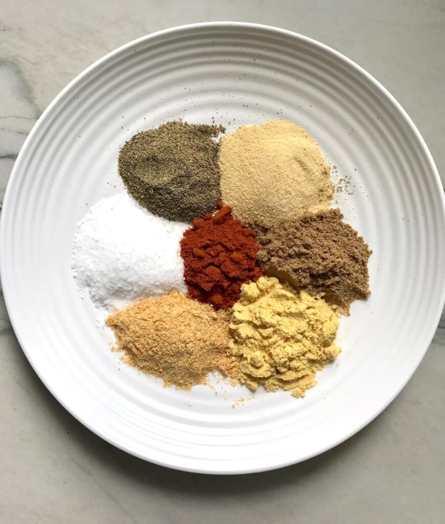 Plate with seven separate seasonings to be blended into this Brazilian Steak Seasoning