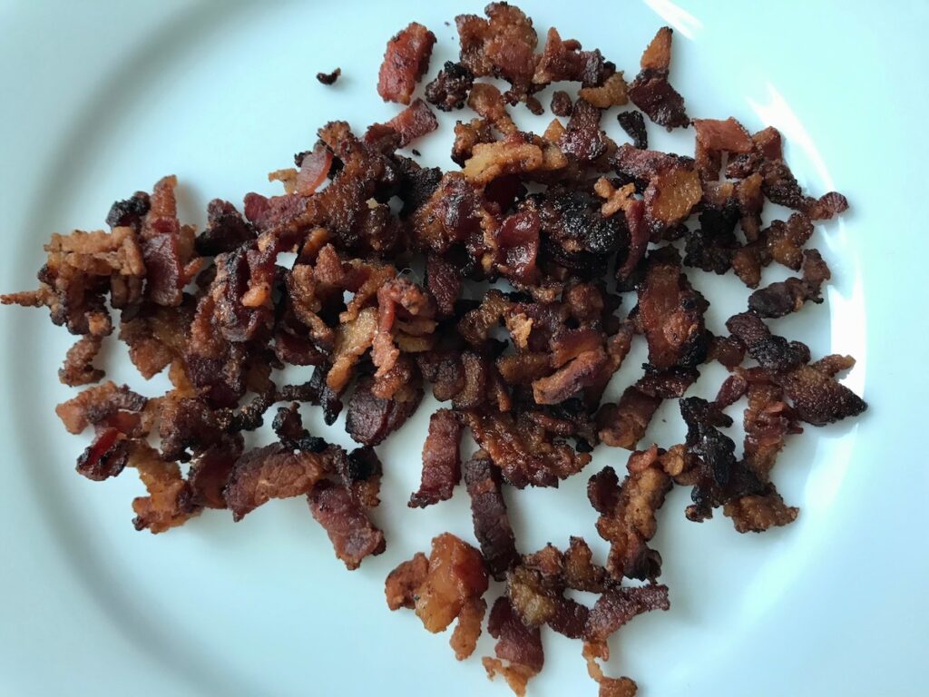 Crispy cooked bacon pieces for this Carrot Bacon Recipe.