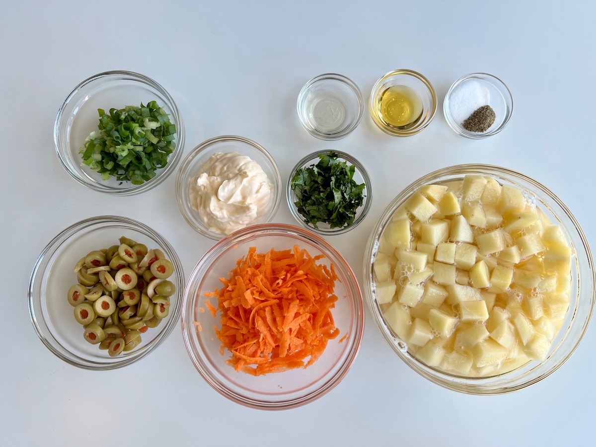 Ingredients prepped, chopped, shredded, and measured out into bowls for Brazilian Potato Salad.