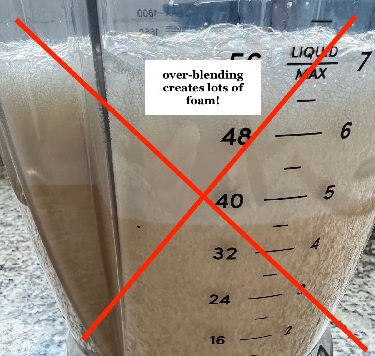 Picture of blender with custard that has lots of foam because it was over-blended for Brazilian Flan recipe. A red X is over the image with a note that says 'over-blending creates tons of foam'.