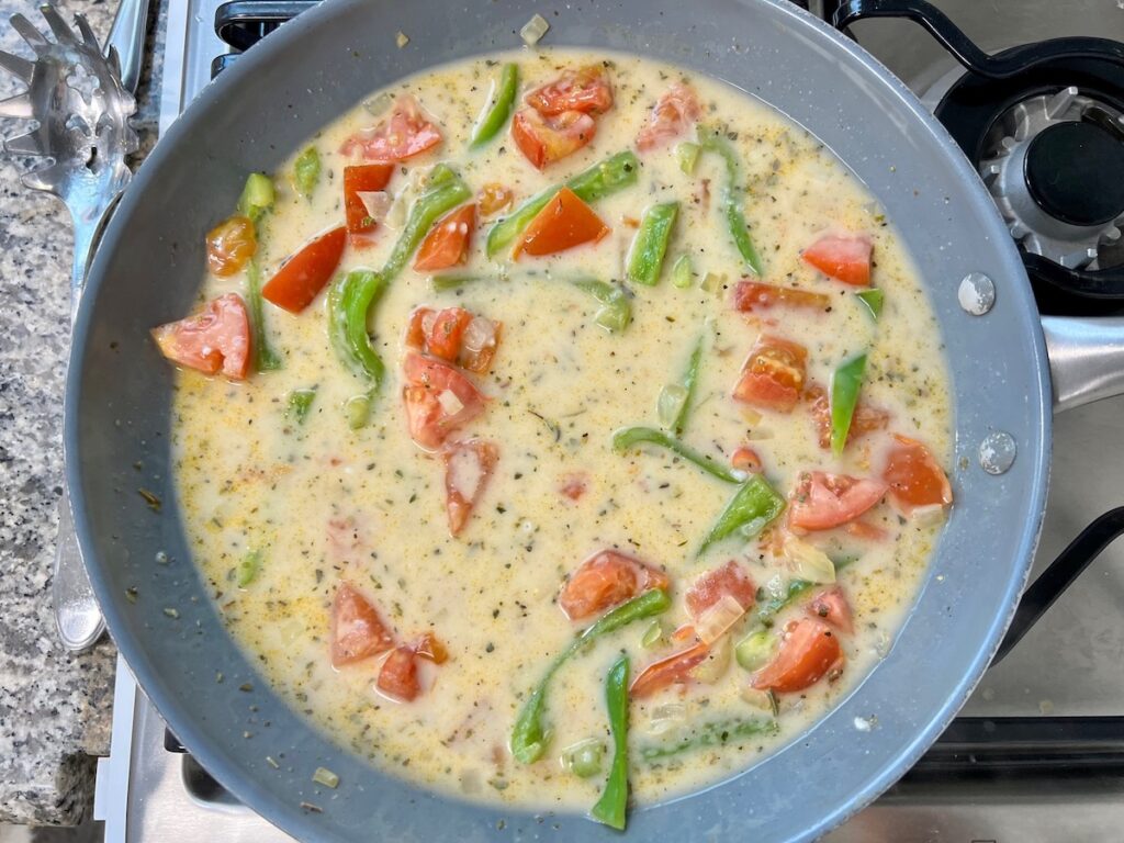 Onions, green pepper, and tomatoes in Coconut Milk Pasta Sauce.