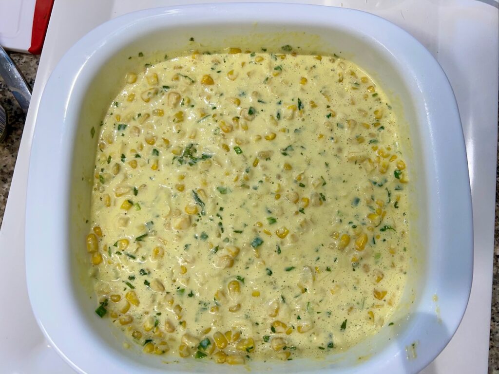 Corn Casserole Recipe with Cream cheese in a casserole dish before baking.