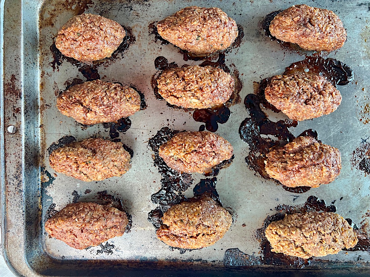 Cooked Kibe on a sheet pan for Mediterranean Ground Beef Kabab recipe.