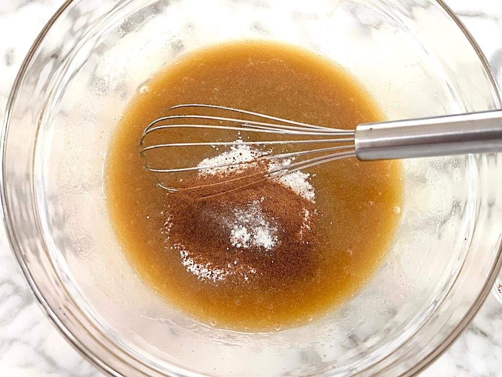 Spices added to batter in clear glass bowl before being mixed for the Pao de Mel recipe, Brazilian cakes filled with dolce de leite and covered with chocolate.