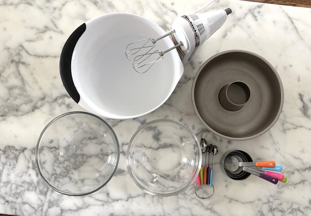 Bowls, mixer, and other kitchen tools needed for this Bolo de Fuba, Cornmeal Cake, recipe.